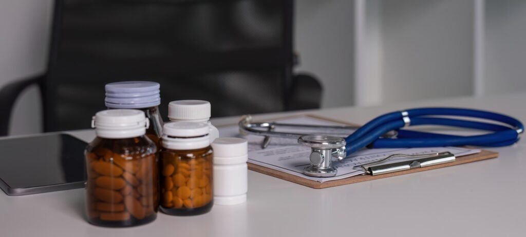 Medicine and stethoscope placed on the doctor's desk health care medicine.