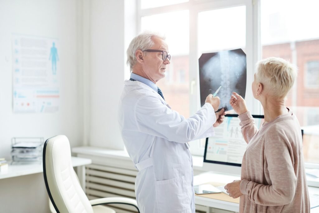 Radiologist showing x-ray image to patient