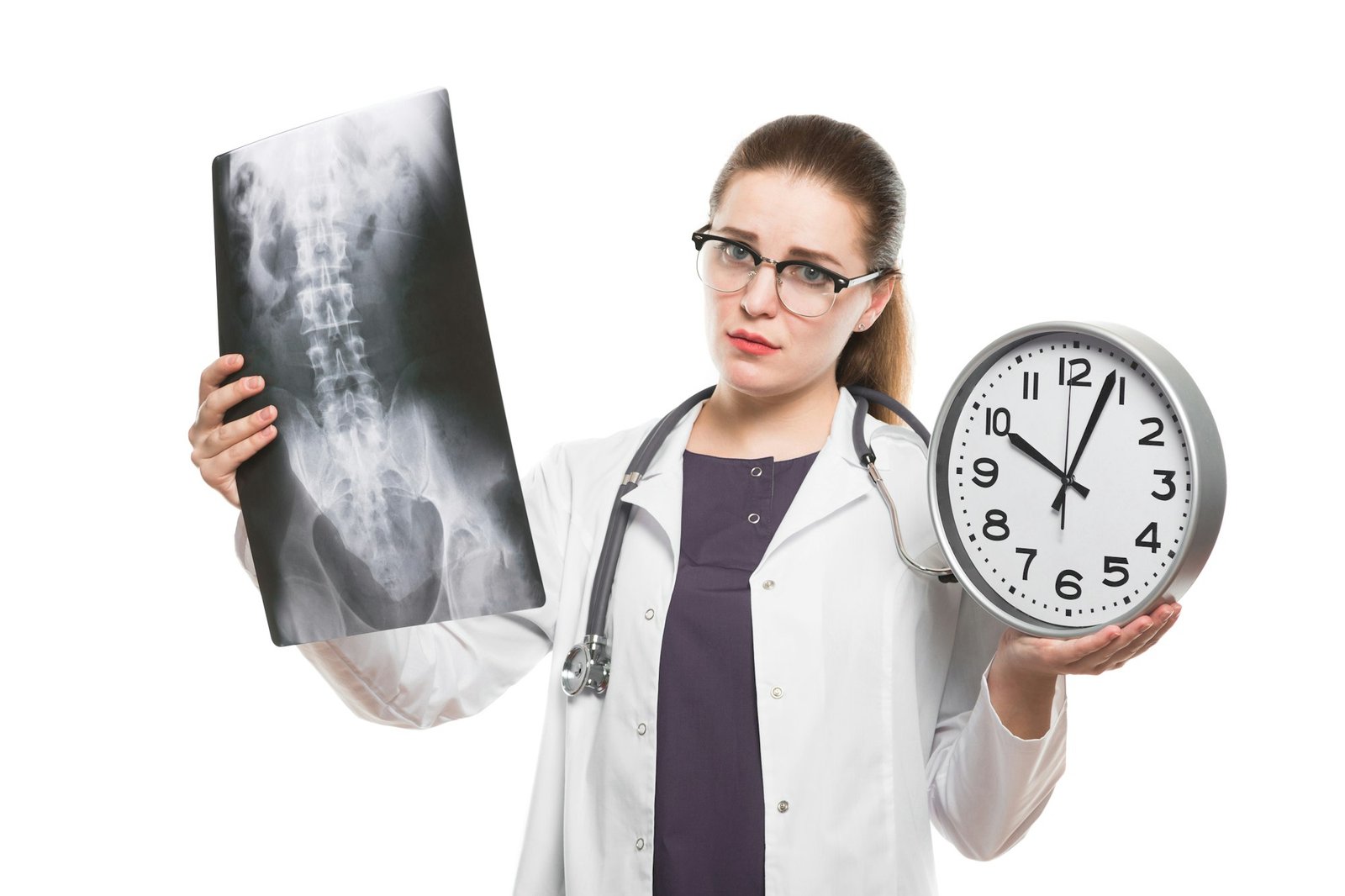 Attractive young woman doctor with clock in her hands with x-ray making diagnosis in white uniform